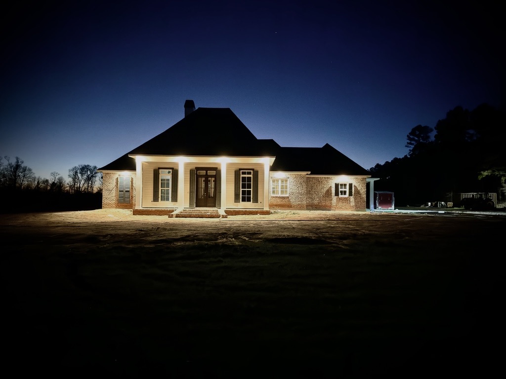 Wide nighttime view of the completed residential exterior
